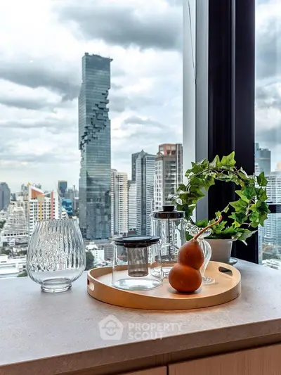 Stunning city view from modern apartment with stylish decor and large windows.