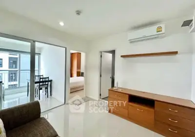 Modern living room with air conditioning and balcony access in a stylish apartment.