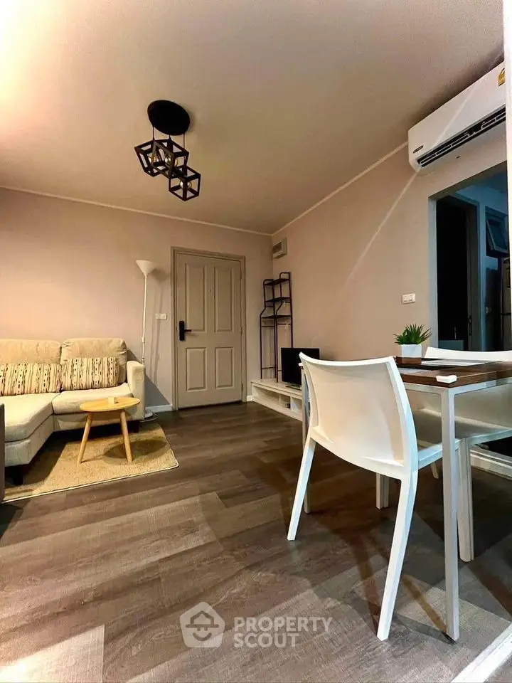 Modern living room with stylish furniture and air conditioning, perfect for cozy gatherings.