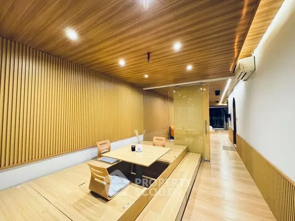 Modern dining area with wooden decor and recessed lighting