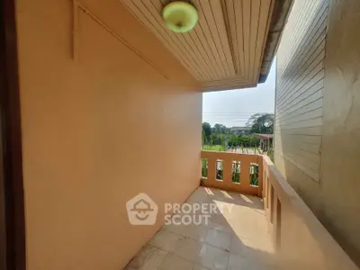 Charming balcony with serene view and ample sunlight, perfect for relaxation.