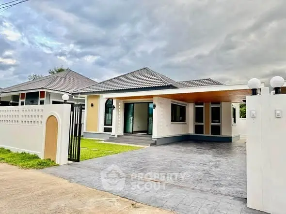 Modern single-story house with spacious driveway and stylish exterior design.