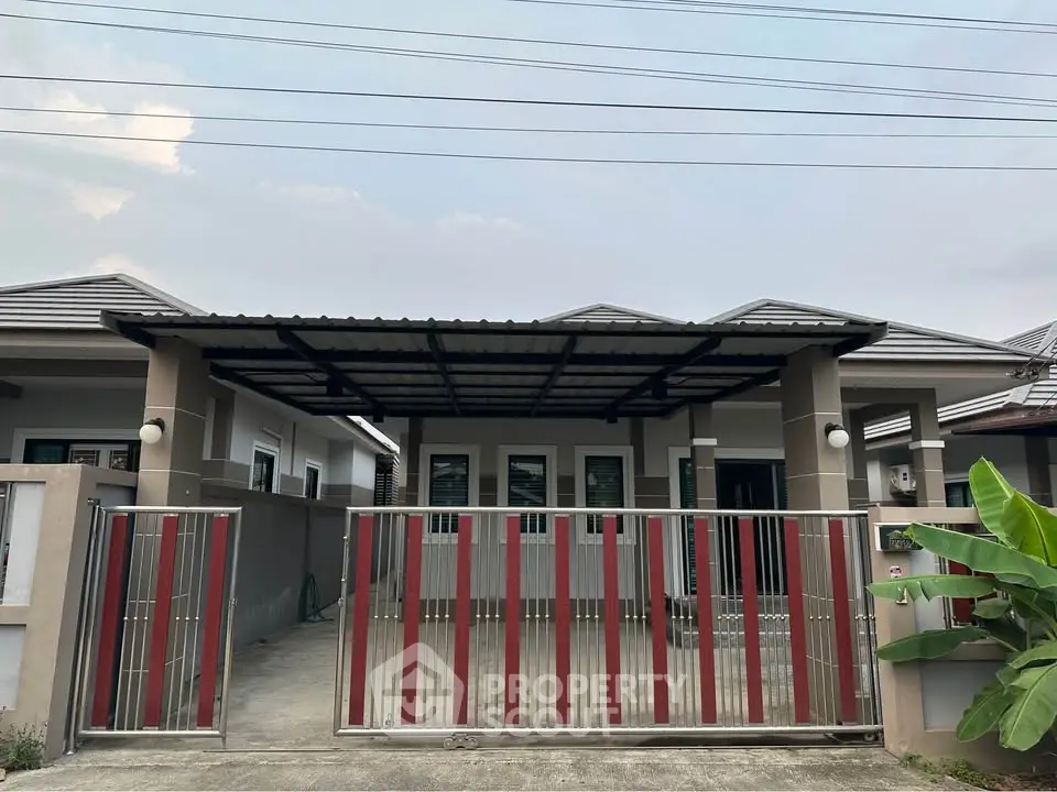 Charming single-story home with modern facade and gated driveway