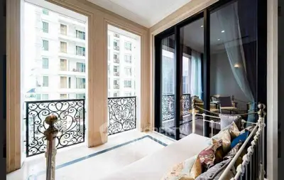 Luxurious balcony with elegant iron railings and cozy seating area, perfect for relaxation.