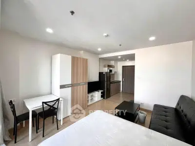 Modern studio apartment with open layout, featuring a cozy living area, compact kitchen, and stylish furnishings.