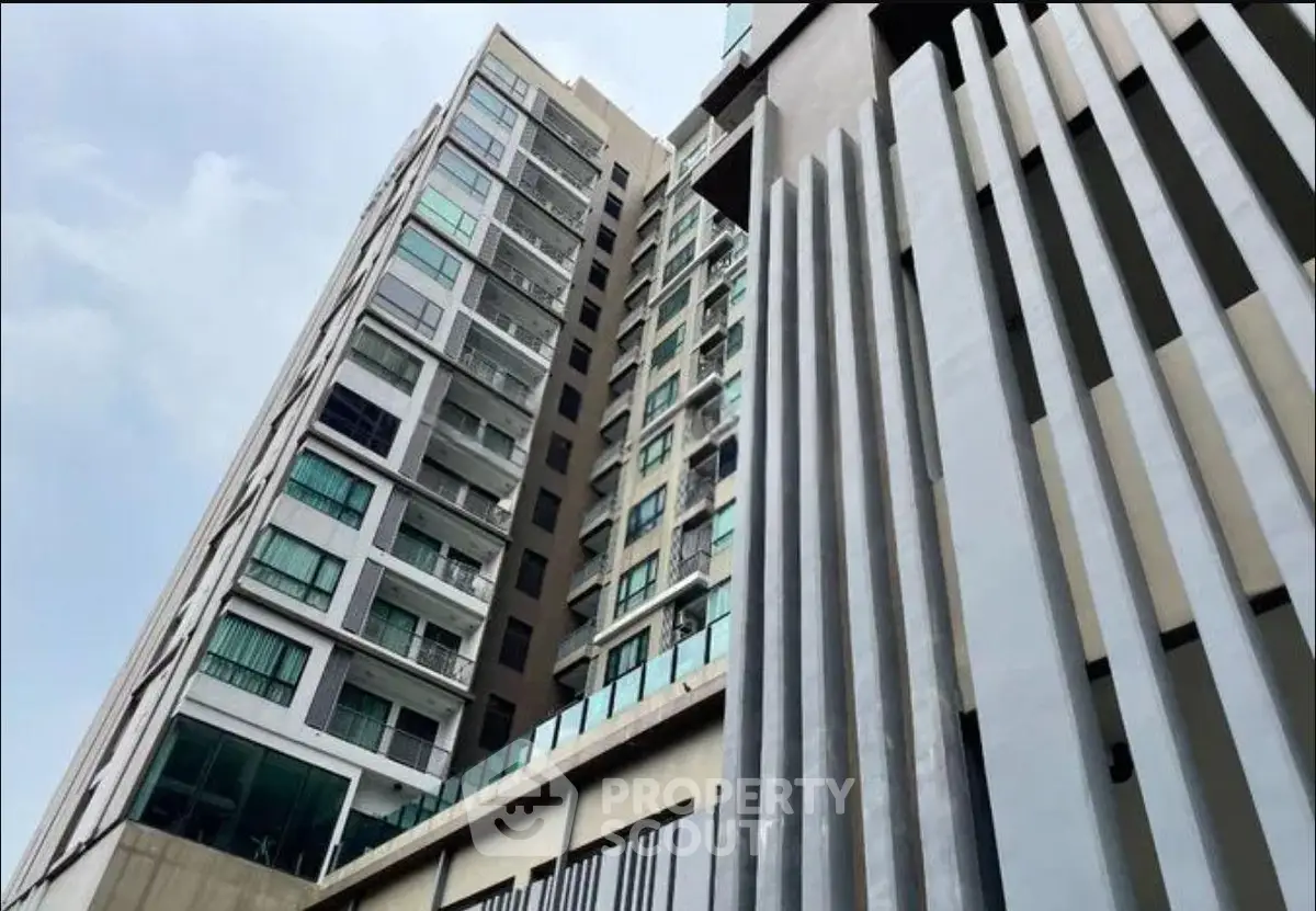 Modern high-rise building with sleek architectural design and large windows.