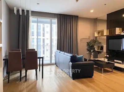 Modern living room with sleek furniture and large windows in a stylish apartment.