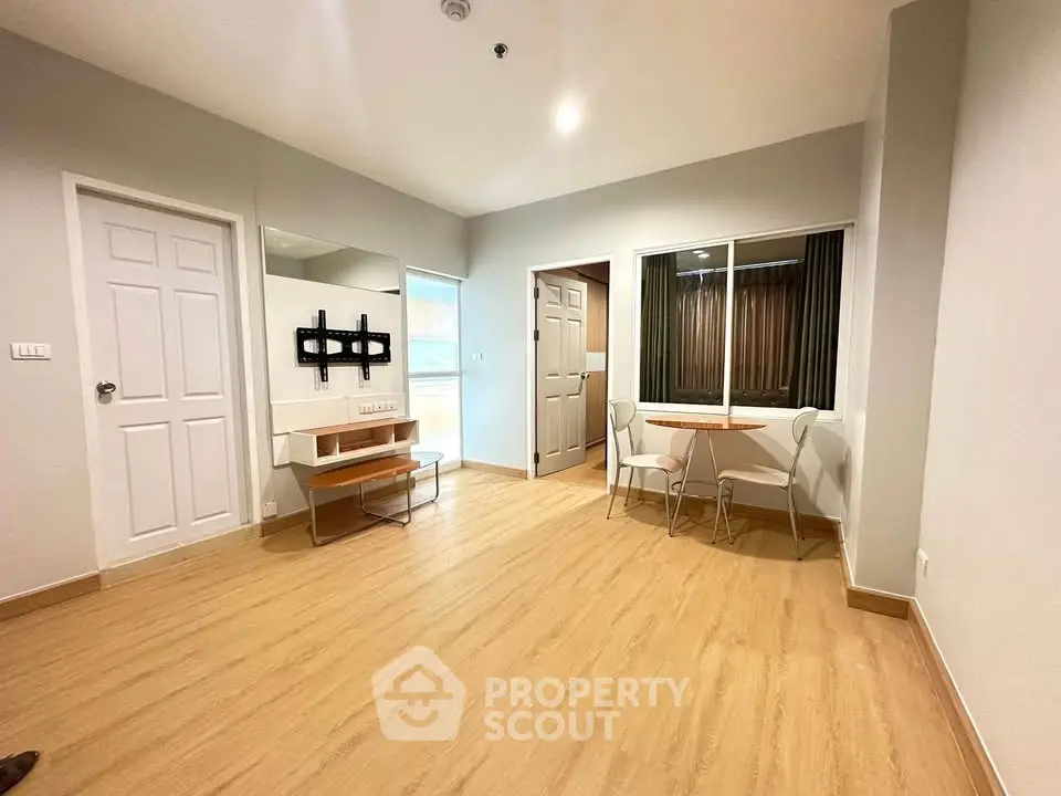 Spacious modern living room with wooden flooring and stylish furniture