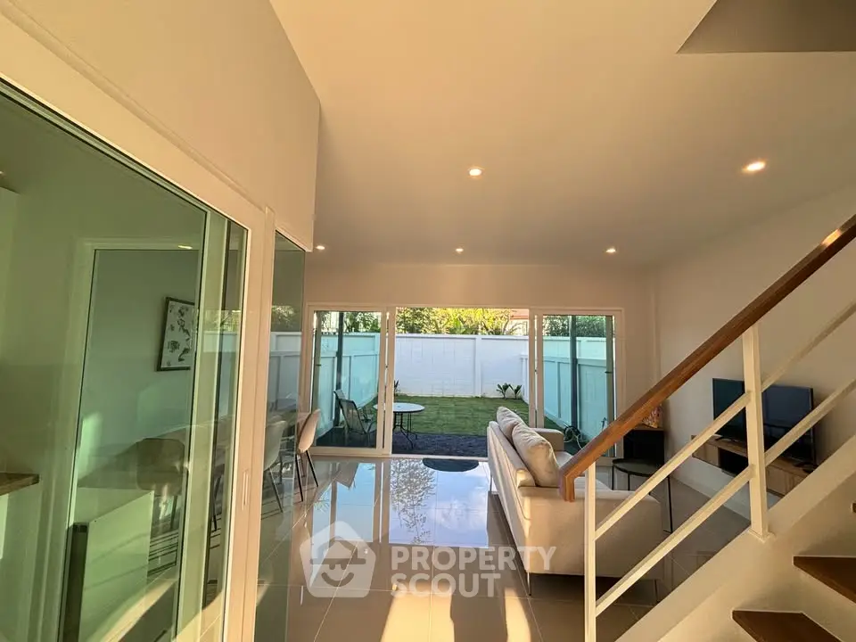 Spacious modern living room with garden view and elegant interior design.