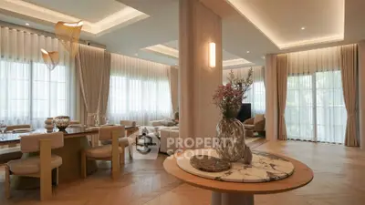 Luxurious open-plan living and dining area with elegant decor and natural light.