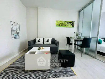 Modern living room with stylish decor and dining area in open layout apartment.