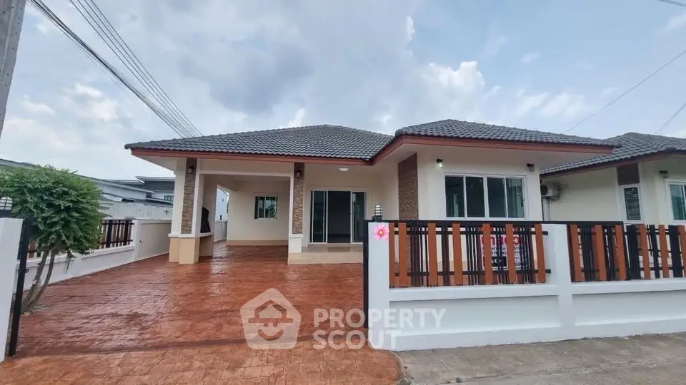 Charming single-story house with spacious driveway and modern exterior design.