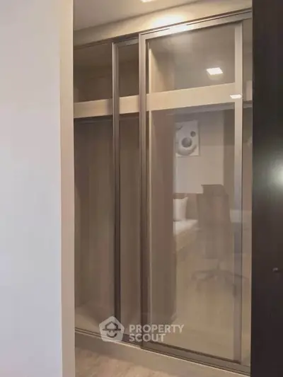 Spacious modern closet with sliding doors in a stylish bedroom setting.