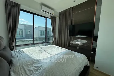 Modern bedroom with large window and stylish decor