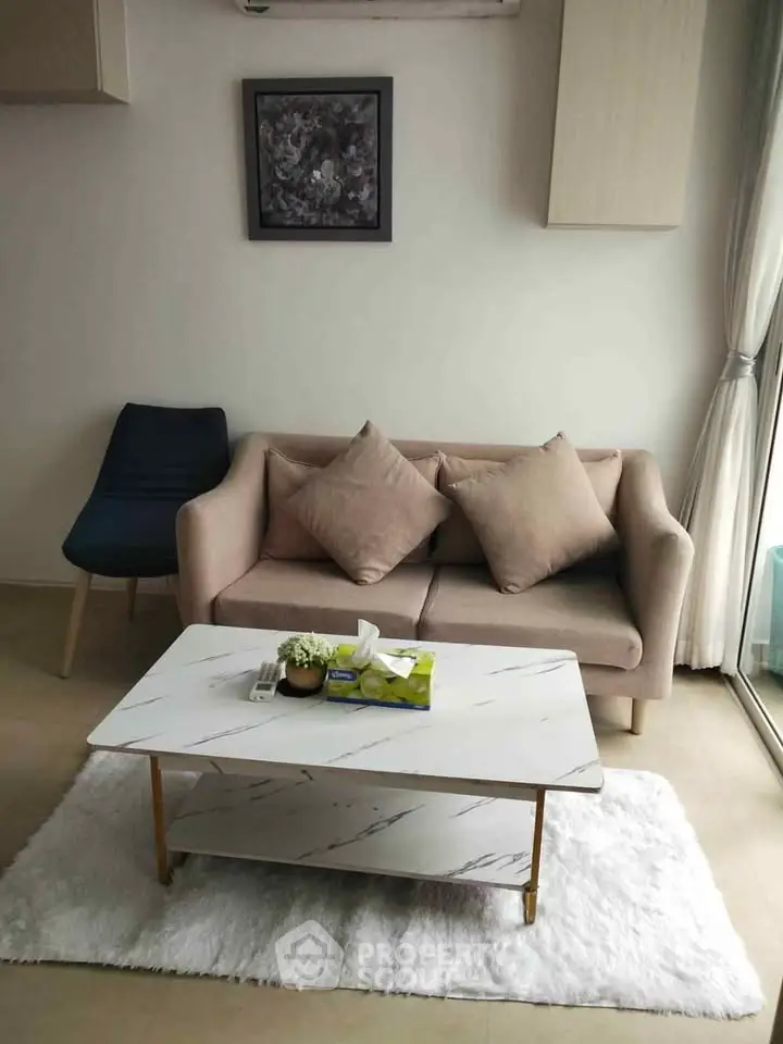 Cozy living room with modern sofa and marble coffee table, perfect for relaxation.