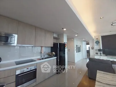 Modern open-layout kitchen with sleek appliances and spacious living area
