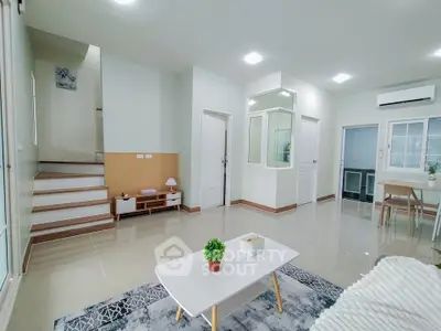 Spacious modern living room with sleek design and natural light, perfect for family gatherings.