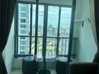 Modern high-rise apartment with stunning city view from balcony.