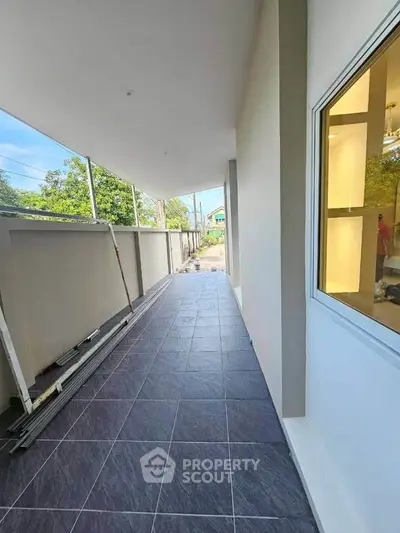 Spacious balcony with modern tiles and scenic view, perfect for relaxation and outdoor enjoyment.