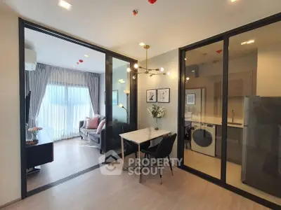 Modern apartment interior with open layout, featuring a cozy living room and sleek kitchen area.