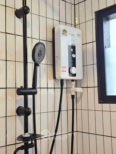 Modern bathroom with sleek shower system and stylish tiled walls.