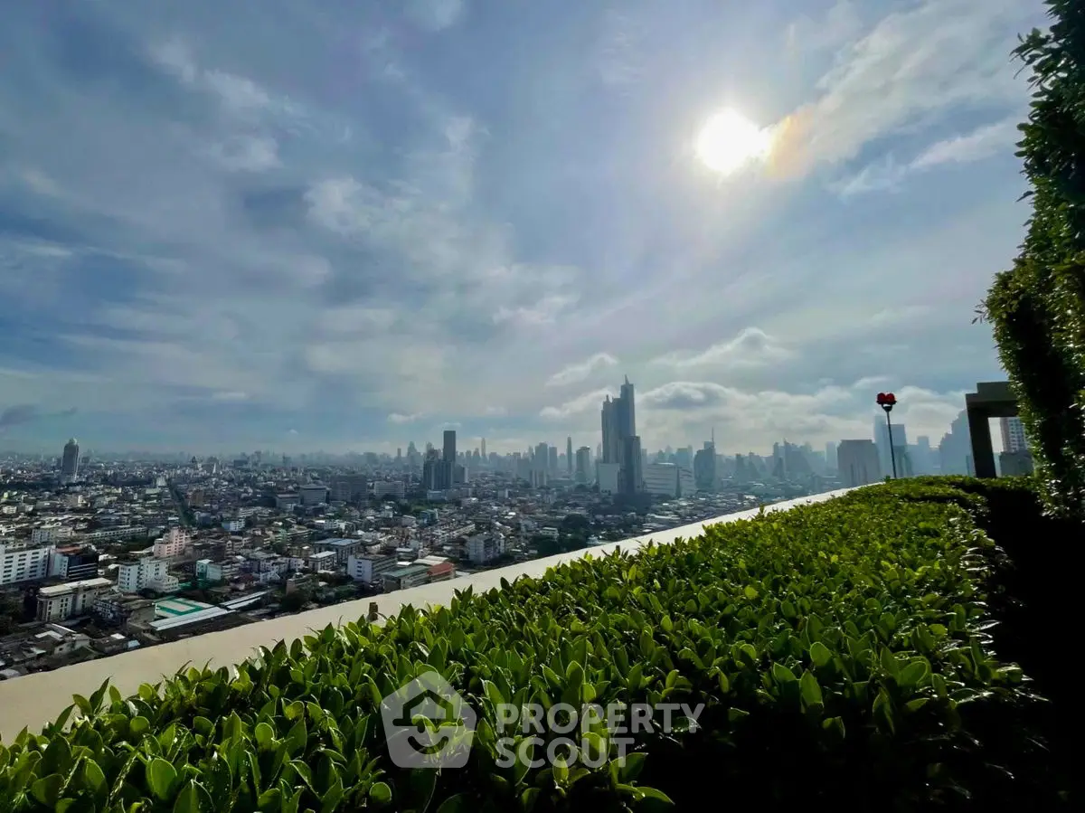 Stunning rooftop view of city skyline with lush greenery and bright sky