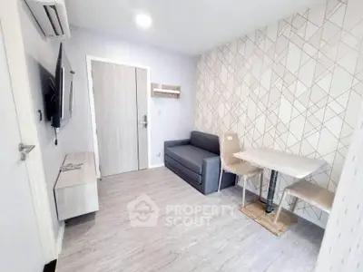 Modern living room with stylish decor and compact furniture in a cozy apartment.