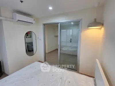 Modern bedroom with sliding glass doors and air conditioning unit