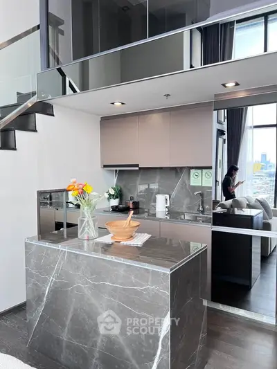 Modern kitchen with marble island and open layout in luxury apartment