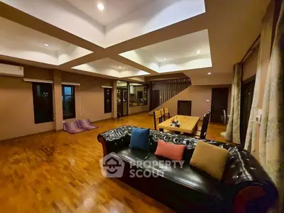 Spacious living room with elegant wooden flooring and modern lighting