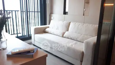 Modern living room with cozy sofa and balcony view