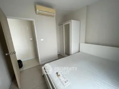 Cozy bedroom with air conditioning and wardrobe in modern apartment