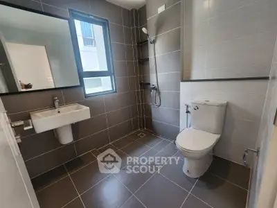 Modern bathroom with sleek gray tiles and contemporary fixtures