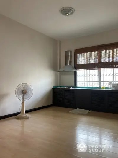 Spacious kitchen with wooden flooring and modern ventilation system