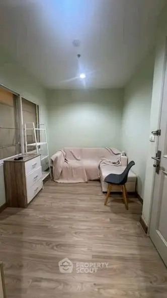 Cozy small living room with wooden flooring and minimalistic furniture