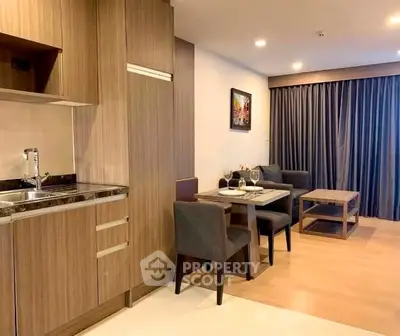 Modern open-layout kitchen and dining area with stylish wood cabinetry and cozy seating.