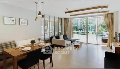 Spacious modern living room with pool view, open layout, and elegant dining area.