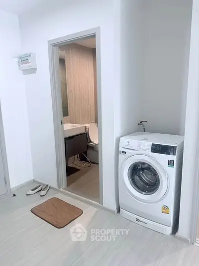 Modern apartment interior with washing machine and bathroom view