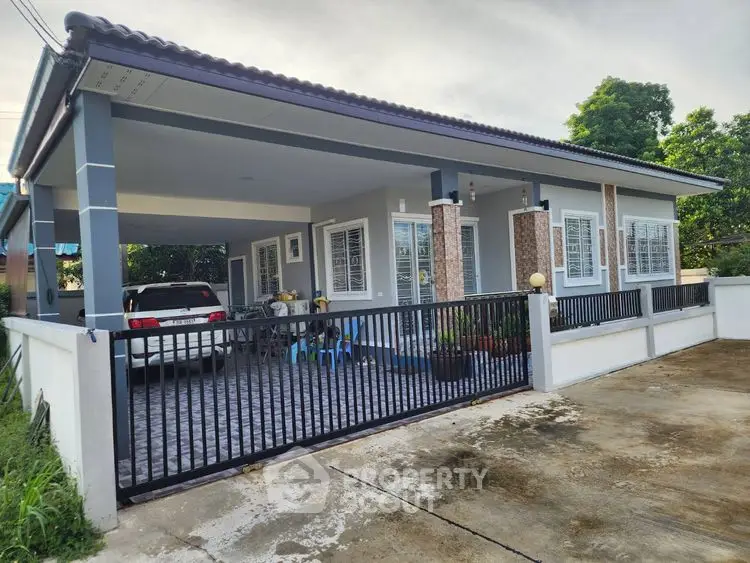 Charming single-story home with spacious carport and modern exterior design.