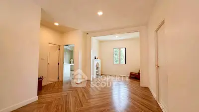 Spacious open-plan living area with elegant wooden flooring and natural light.