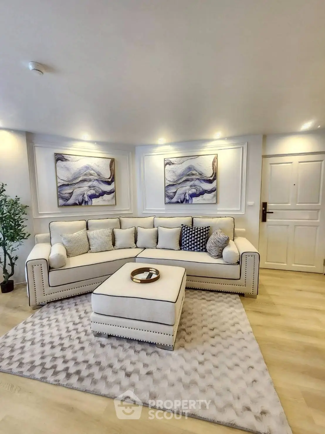 Elegant living room with plush sofa, modern decor, and ambient lighting for a cozy atmosphere.