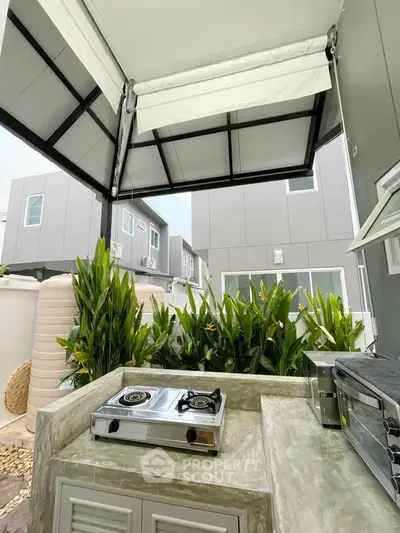 Modern outdoor kitchen with gas stove and sleek design in contemporary home