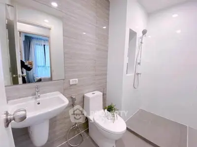 Modern bathroom with sleek fixtures and spacious shower area