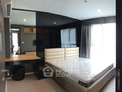 Modern bedroom with large windows and stylish decor in a contemporary apartment.