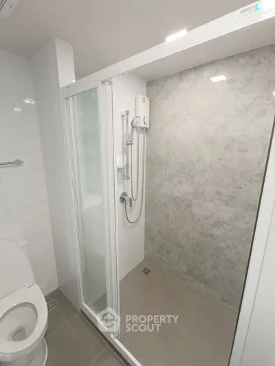 Modern bathroom with sleek shower enclosure and tiled walls