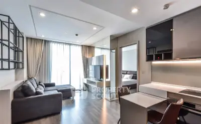 Modern living room with sleek design and natural light, featuring a cozy sofa and stylish decor.