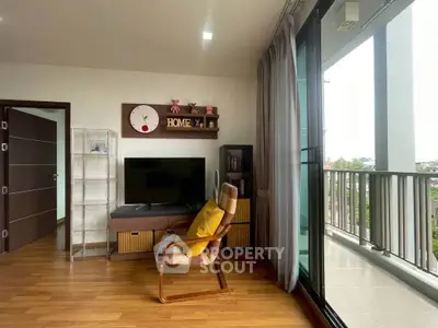 Modern living room with balcony view, featuring stylish decor and ample natural light.