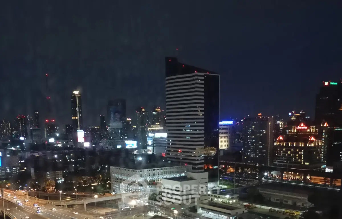Stunning cityscape view showcasing a vibrant skyline with illuminated skyscrapers at night.