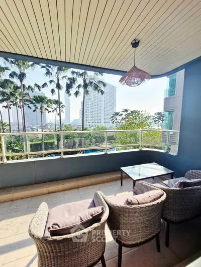Spacious balcony with stunning city view and cozy seating area, perfect for relaxation and entertaining.