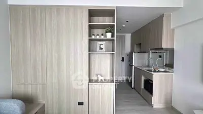 Modern minimalist kitchen with sleek cabinetry and open layout in a stylish apartment.